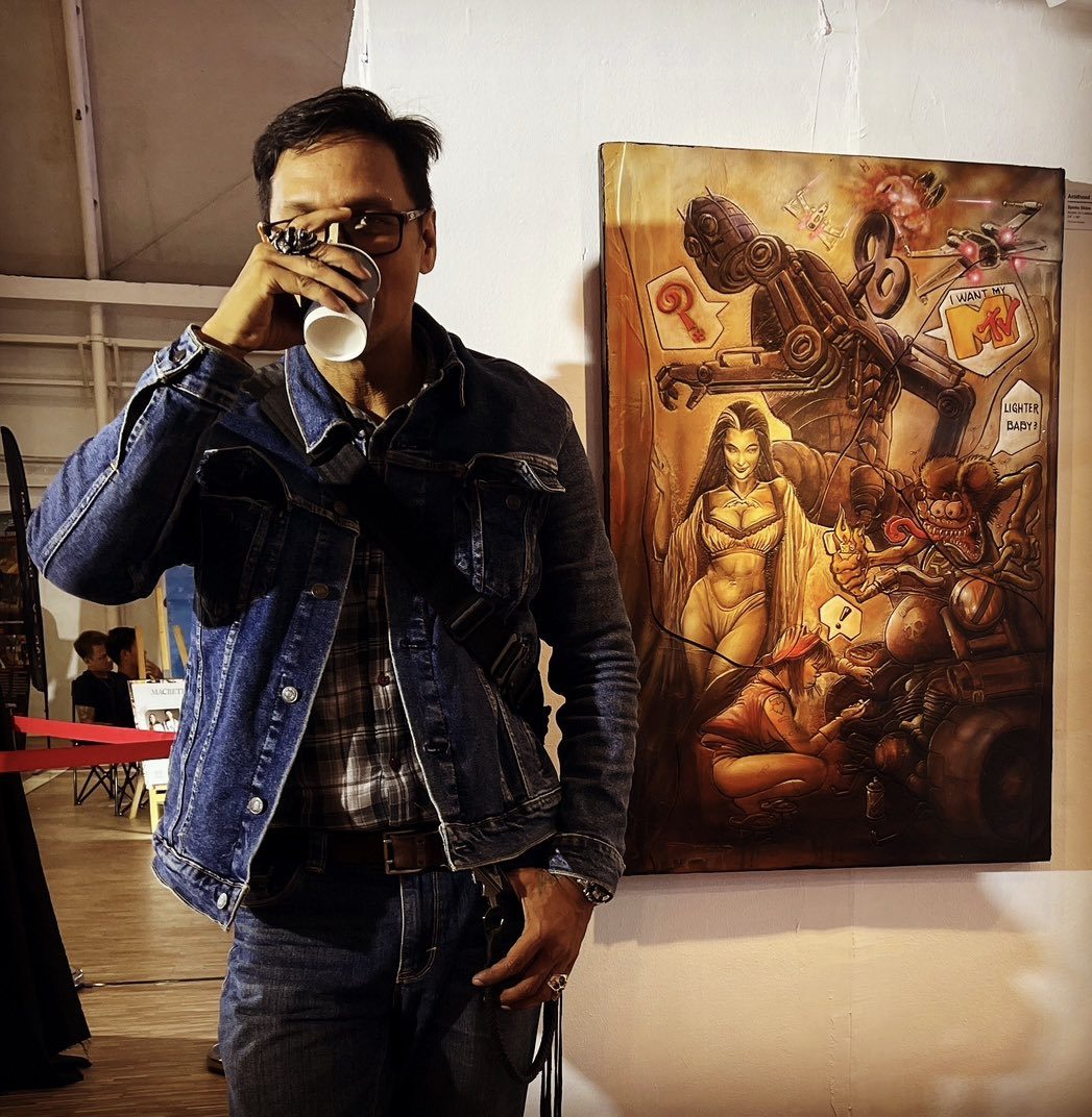 Acidhead at an exhibition opening beside his work